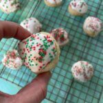 Italian Christmas cookies are soft, poofy sugar cookies topped with a sweet almond glaze and colorful sprinkles.