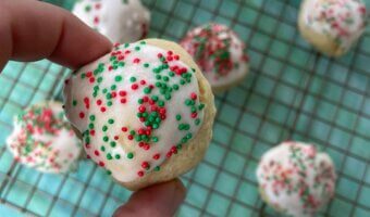 Italian Christmas cookies are soft, poofy sugar cookies topped with a sweet almond glaze and colorful sprinkles.