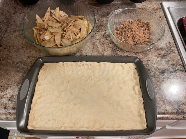IMG_1590 - Mom to Mom Nutrition A cozy sheet pan apple pie made with premade pie crusts, cinnamon-spiced apples, and a brown sugar crumble. Perfect for holidays, potlucks, and feeding a crowd—without the fuss.